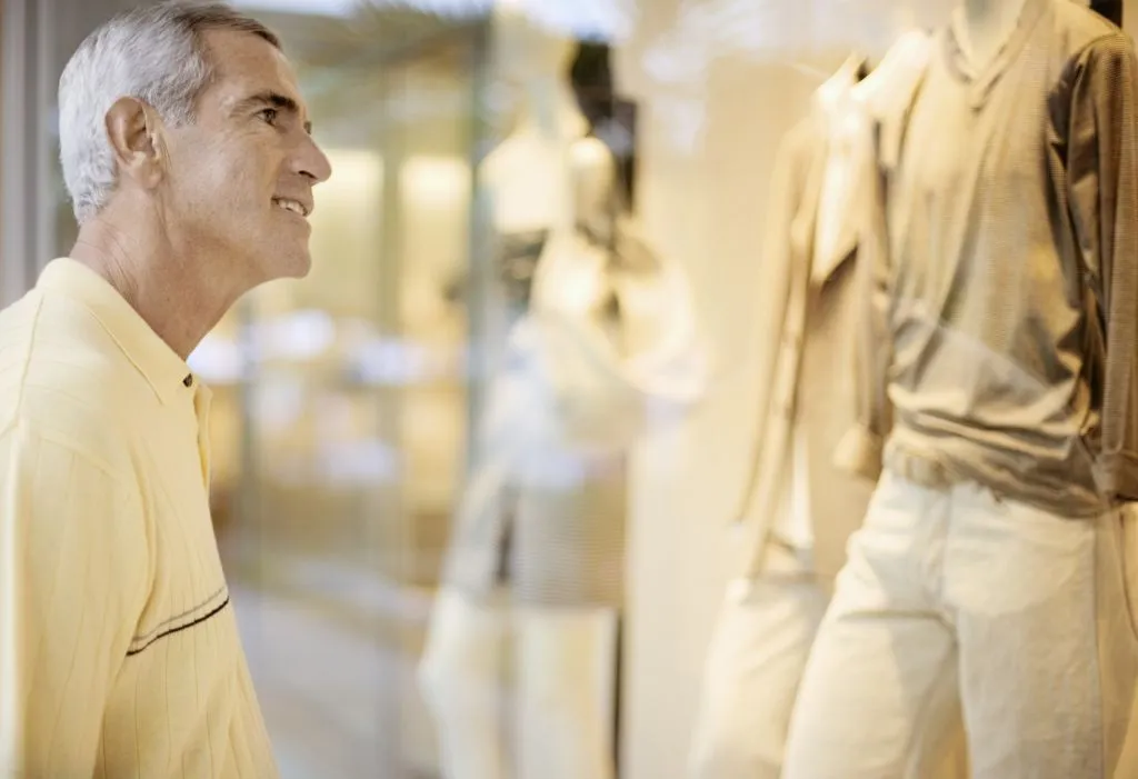 Man looking through glass shopfront window