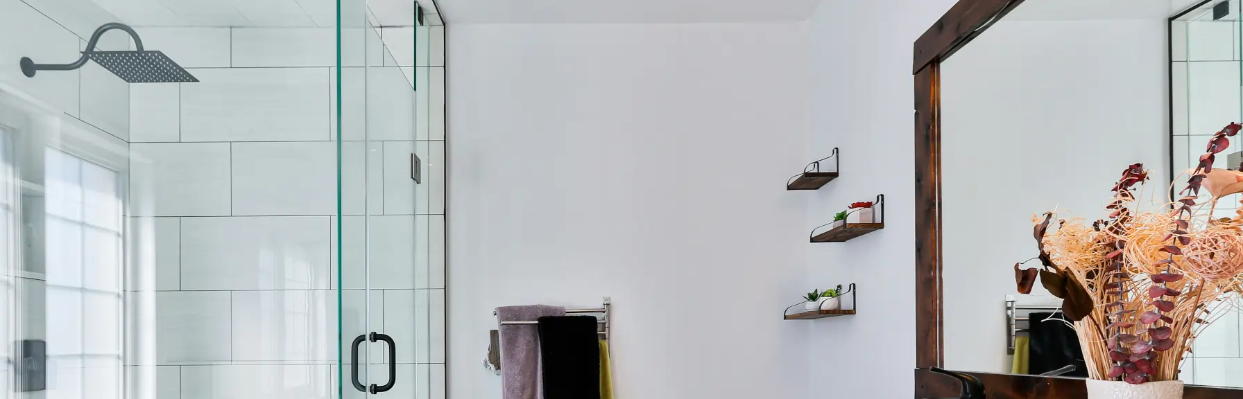 Bathroom frameless shower screen with reflected framed glass window and large wood frame mirror